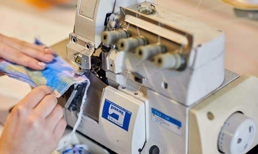Student using textile machine in class