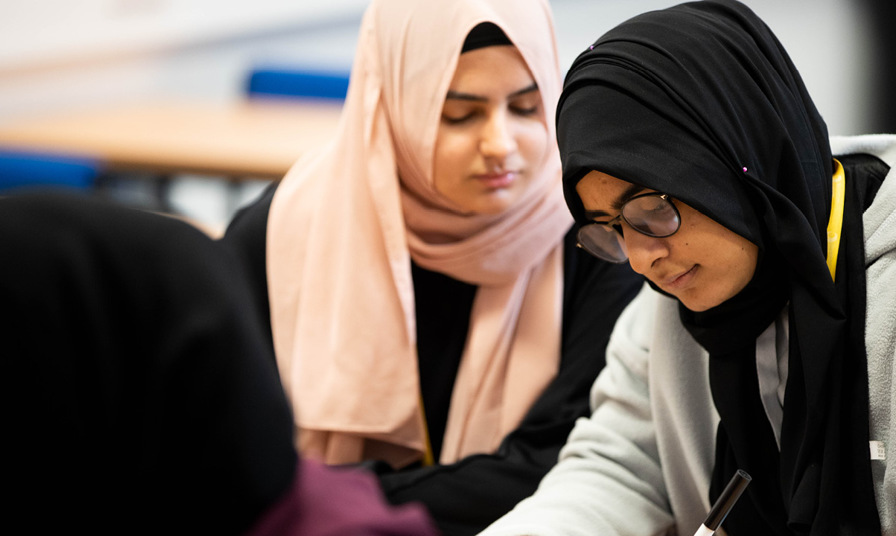 close up of 2 female students wearing headscarves
