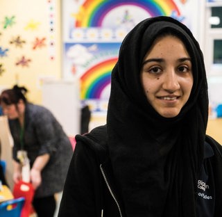 student in foreground of early years setting