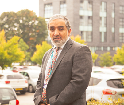 Portrait of Dr Fazal Dad stood in Blackburn College car park