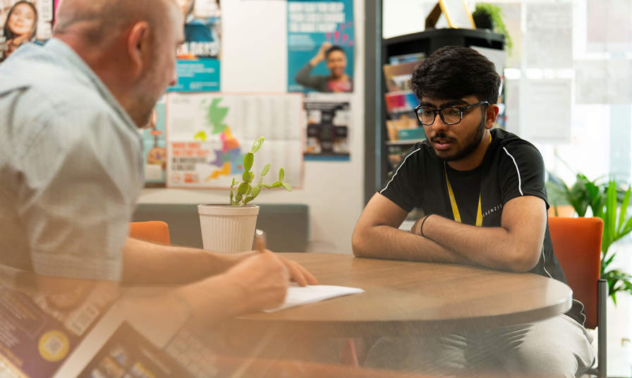 Staff and student having a conversation