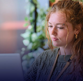 female student sat with laptop