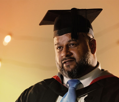 Ali Ahmed in graduation cap and gown