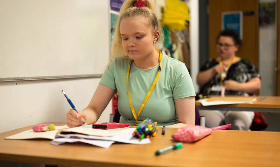Girl sat a table studying 