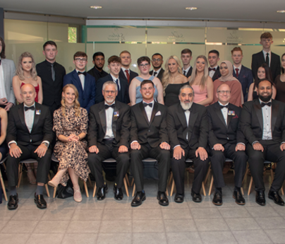 group of people in smart dress and black tie smiling to camera