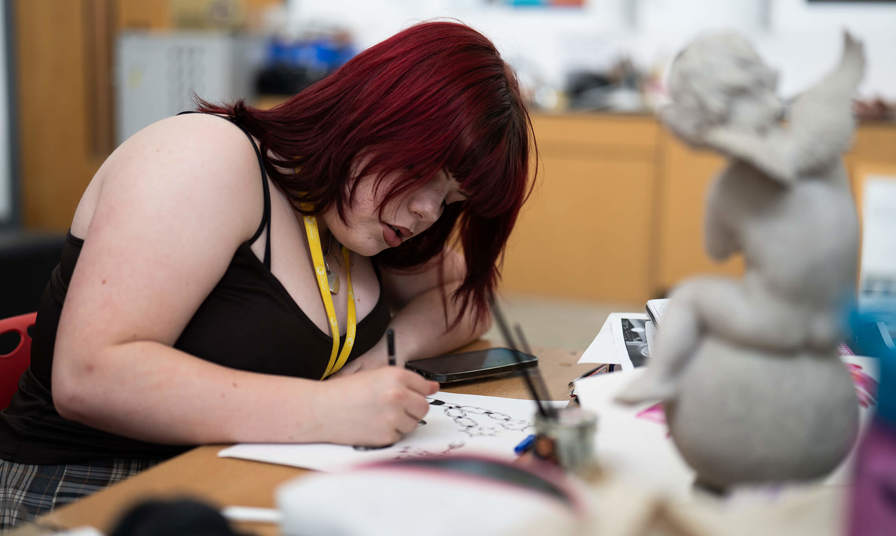 A girl drawing on paper