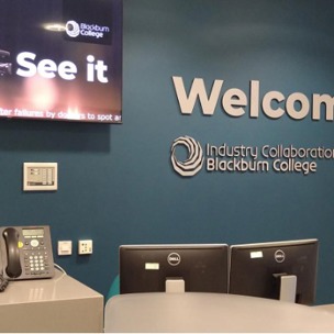 Reception area with TV screen and Welcome Industry Collaboration Zone Blackburn College on wall