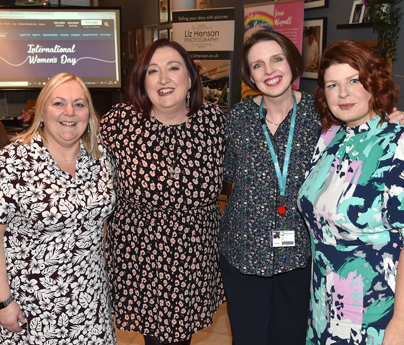 group of women smiling to camera for International Womens Day