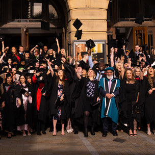 Large group of graduates throwing hats into the air