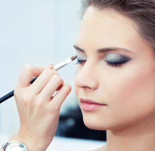 close up of person applying eyeshadow to client