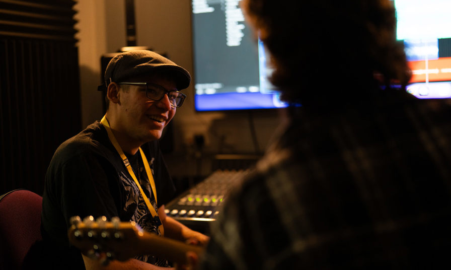 two students in a recording studio