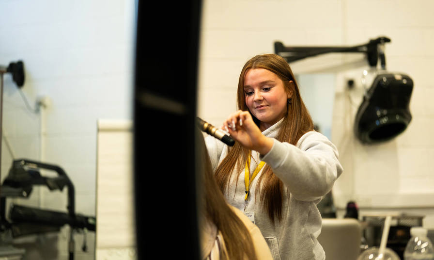 female student styling hair