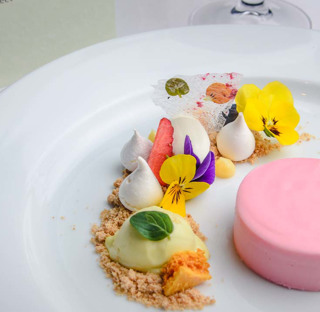 close up of beautifully presented dessert with many colours and flowers