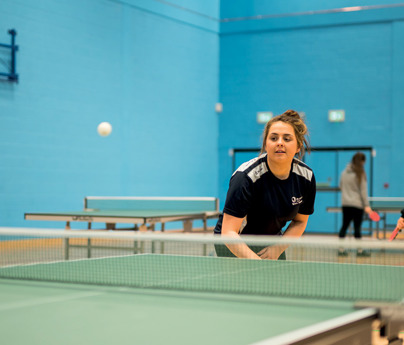 female sports student playing table tennis