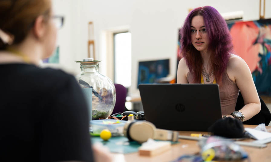 Girl on a laptop in an art class 
