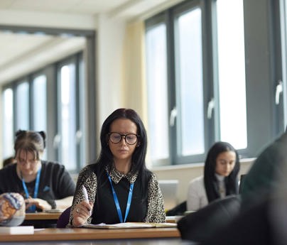 students writing notes on the desk