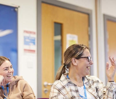 students smiling and laughing during classroom discussion