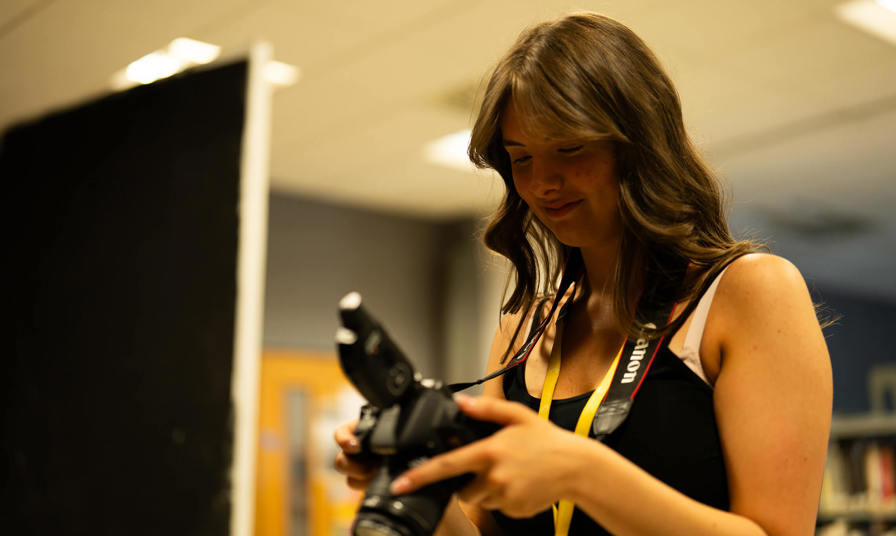 Young woman looking at a photo taken on a camera