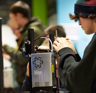 young man works on parts of computer