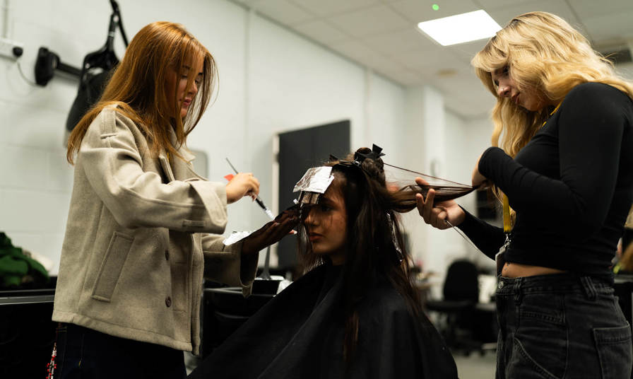 students styling hair 