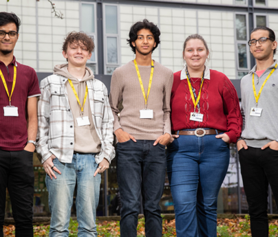 group of students stood smiling to camera