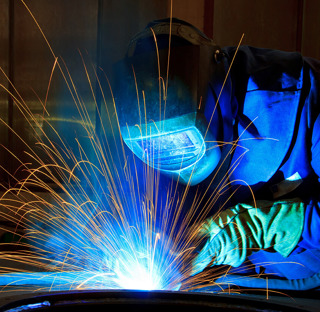 Person welding with sparks flying