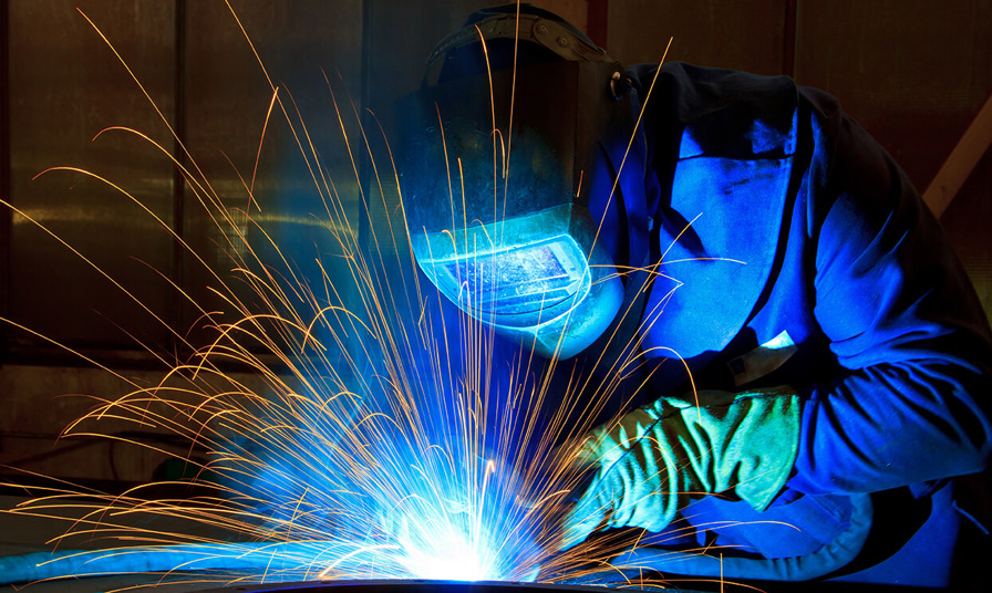 Person welding with sparks flying