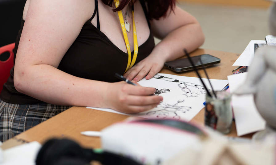 Image of a girl drawing on paper