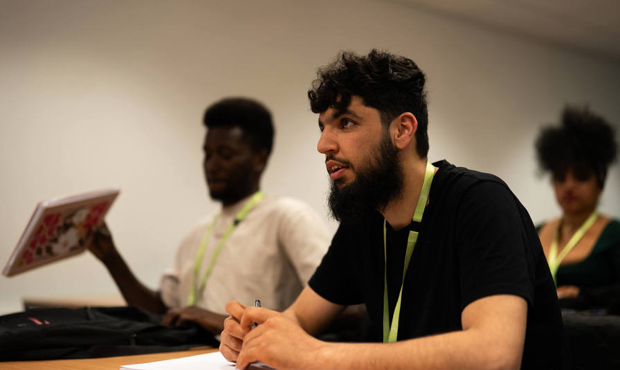 Students sat at a table during a lecture 