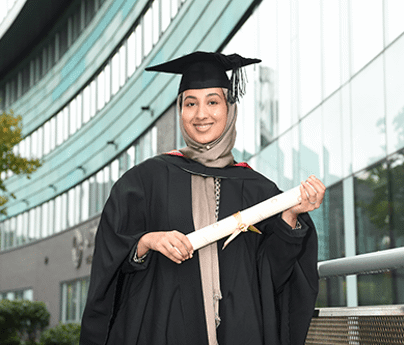 Lamisa Ugradar stood in graduation robes holding degree smiling