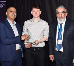 Morgan Grimshaw holding his FE Star Award with the principal and another man
