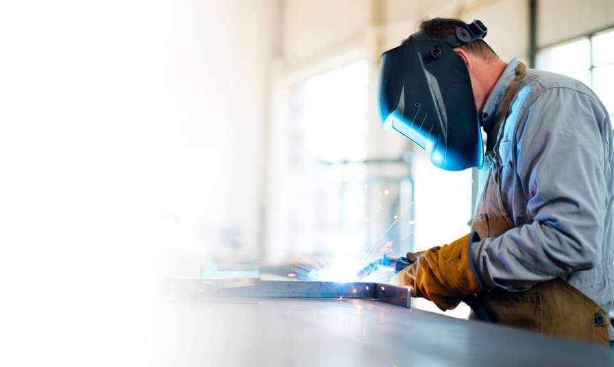 Person using blow torch welding metal