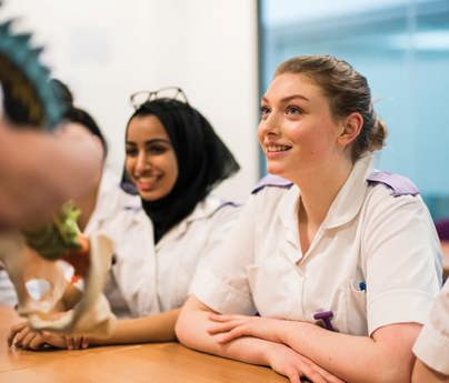 student cadet nurses in classroom listening to tutor