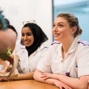 student cadet nurses in classroom listening to tutor