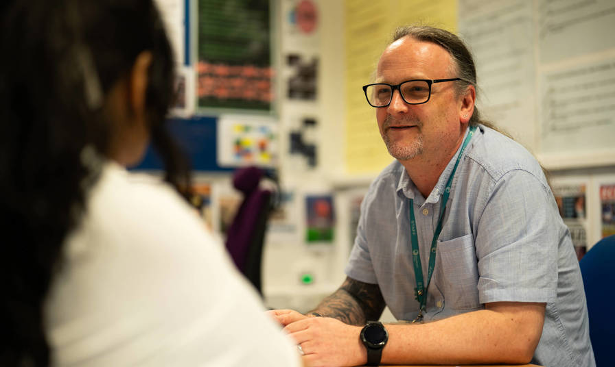 Staff and student having a conversation 