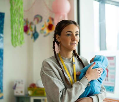 Student holding artificial baby 