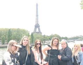 group of student stand bank in front of Eiffel tower