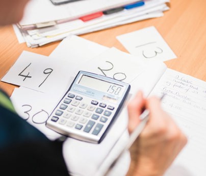 close up of work book and calculator