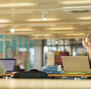 Two students studying in a communal space.