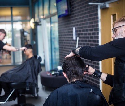 close up of barber cutting hair