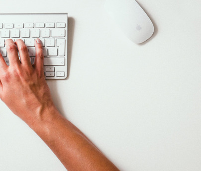 close up of hands typing on keyboard