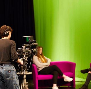 Student filming in media studio