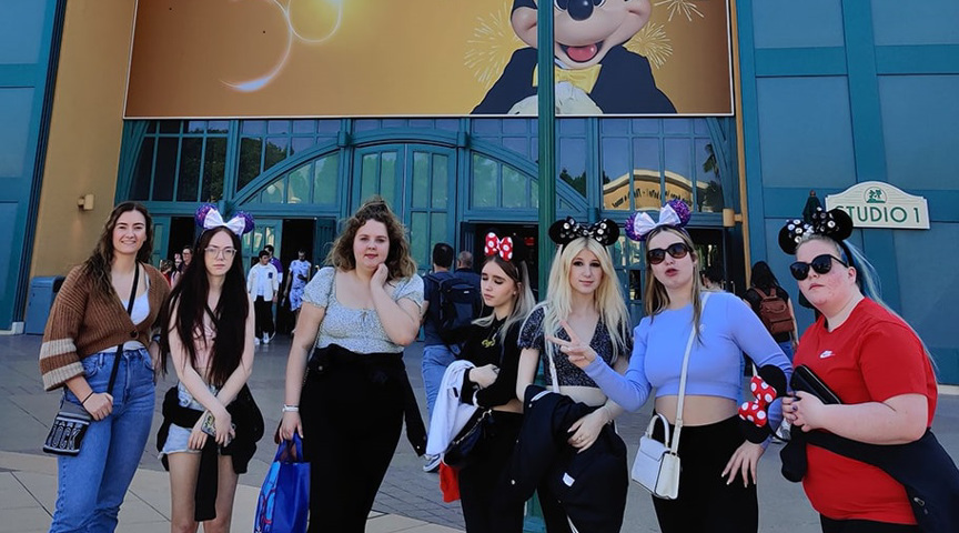 group of students stood outside entrance to DisneyLand Paris