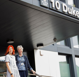 2 people stood outside Duke Street council offices Blackburn