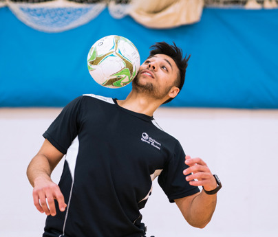 sports student playing with football