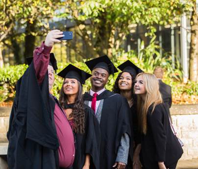 group of graduates pose for selfie