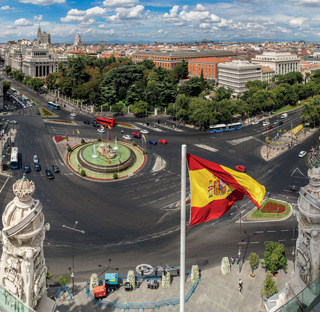 view of city in spain with spanish flag flying