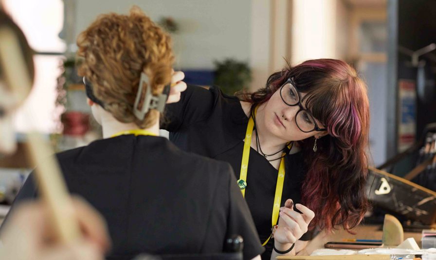 Media Makeup students applying makeup to face