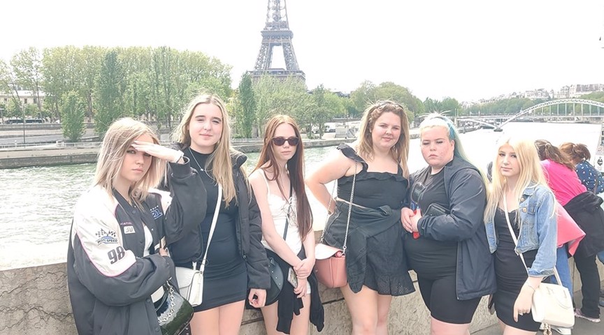 group of students stood on bank with Eiffel Tower in background