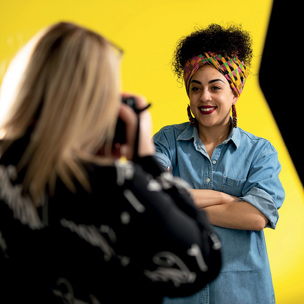 woman poses for photo in bright studio
